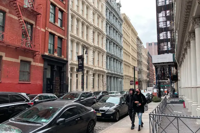 A photo of two people walking in SoHo